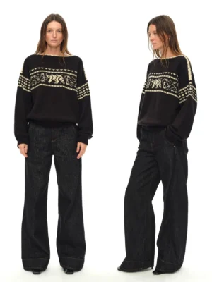 Front full-body view of black loose-fit Nordic folk jacquard sweater with cream polar bear pattern and wide boat neckline