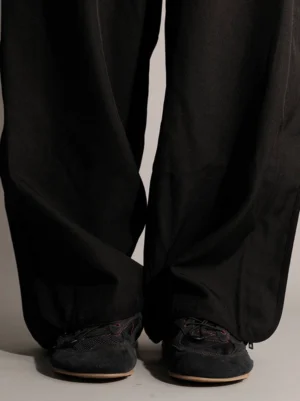 Black nubuck low-profile streetwear trainers styled with wide-leg trousers