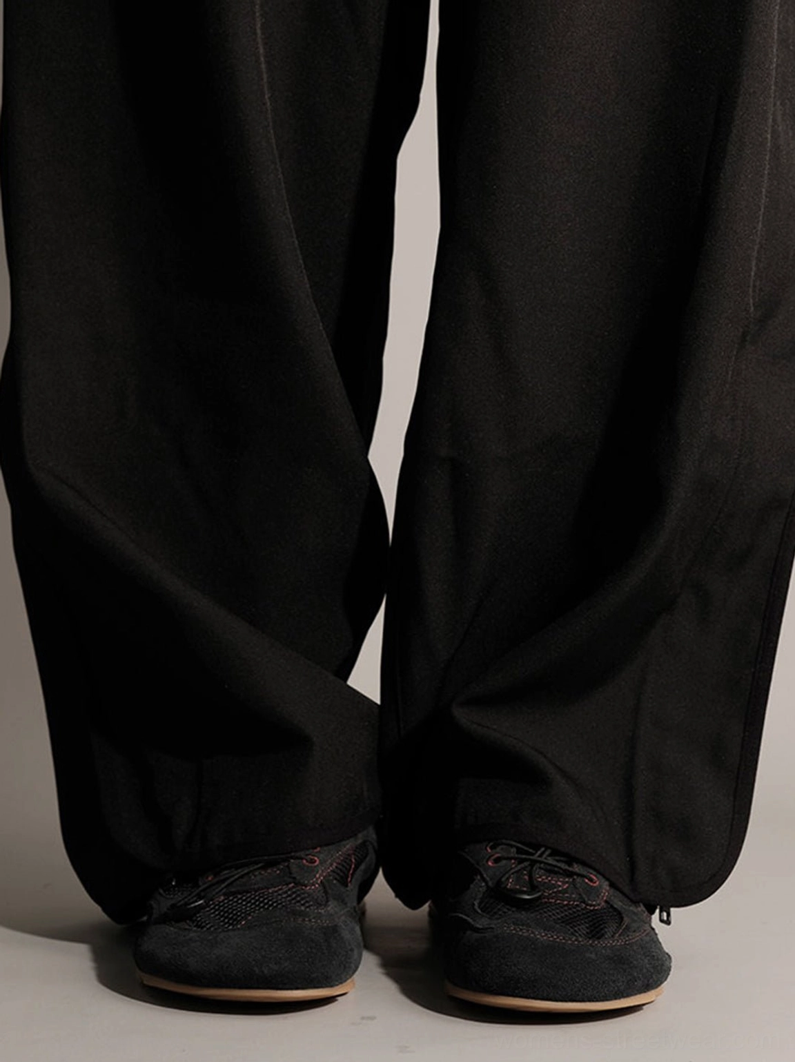Black nubuck low-profile streetwear trainers styled with wide-leg trousers