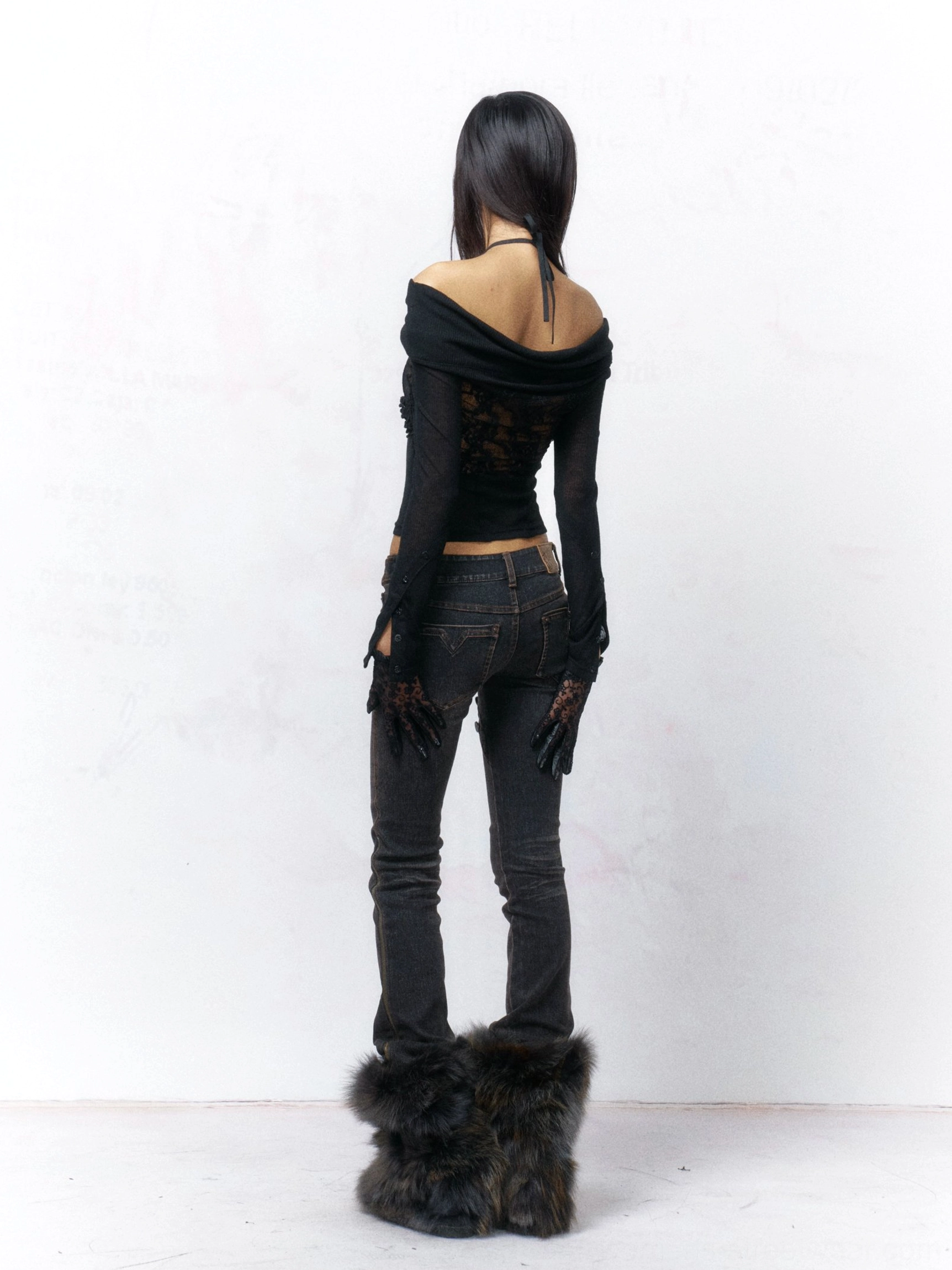 Back view of a black off-shoulder lace top with halter tie closure, exposed back detail, sheer sleeves, and fitted Korean streetwear silhouette