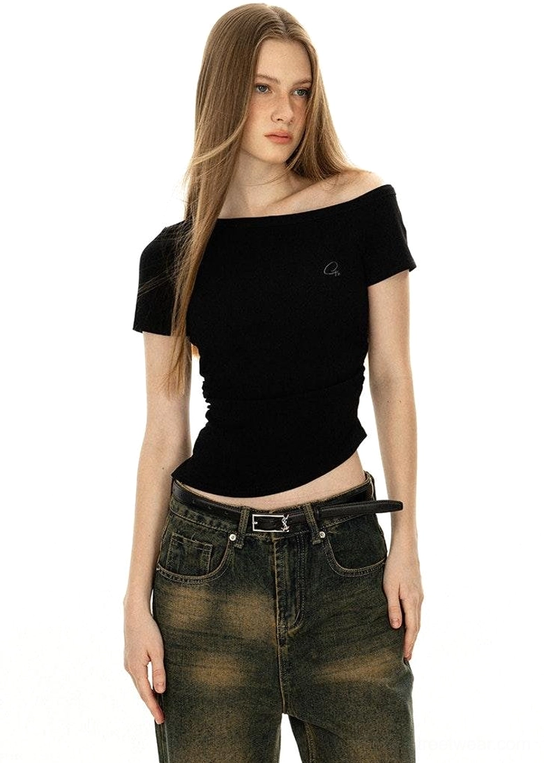Off-shoulder pure black minimalist tee with boat neckline short sleeves styled with tailored trousers East Asian fashion forward