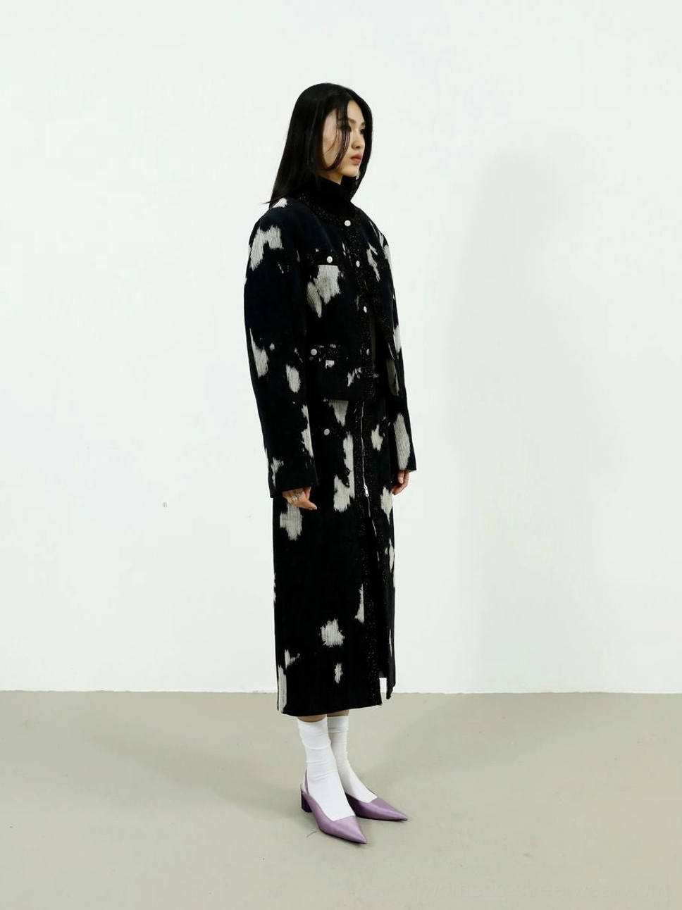 Full-length black and off-white printed midi skirt paired with a matching statement coat, white socks, and purple pointed heels