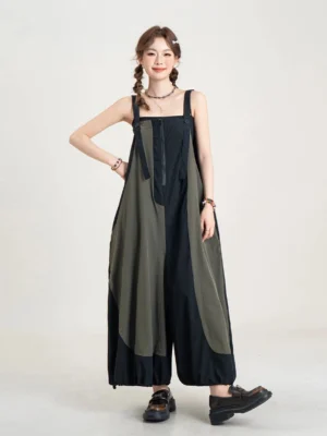 Front view of a black and olive color-block balloon-leg streetwear jumpsuit with adjustable straps, front zipper, oversized wide legs, and drawcord cuffs