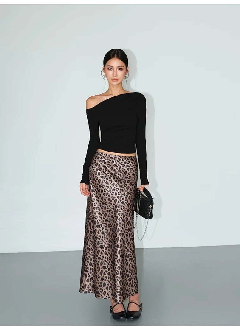 Black fitted one-shoulder long-sleeve streetwear tee paired with a leopard print satin skirt and ballet flats