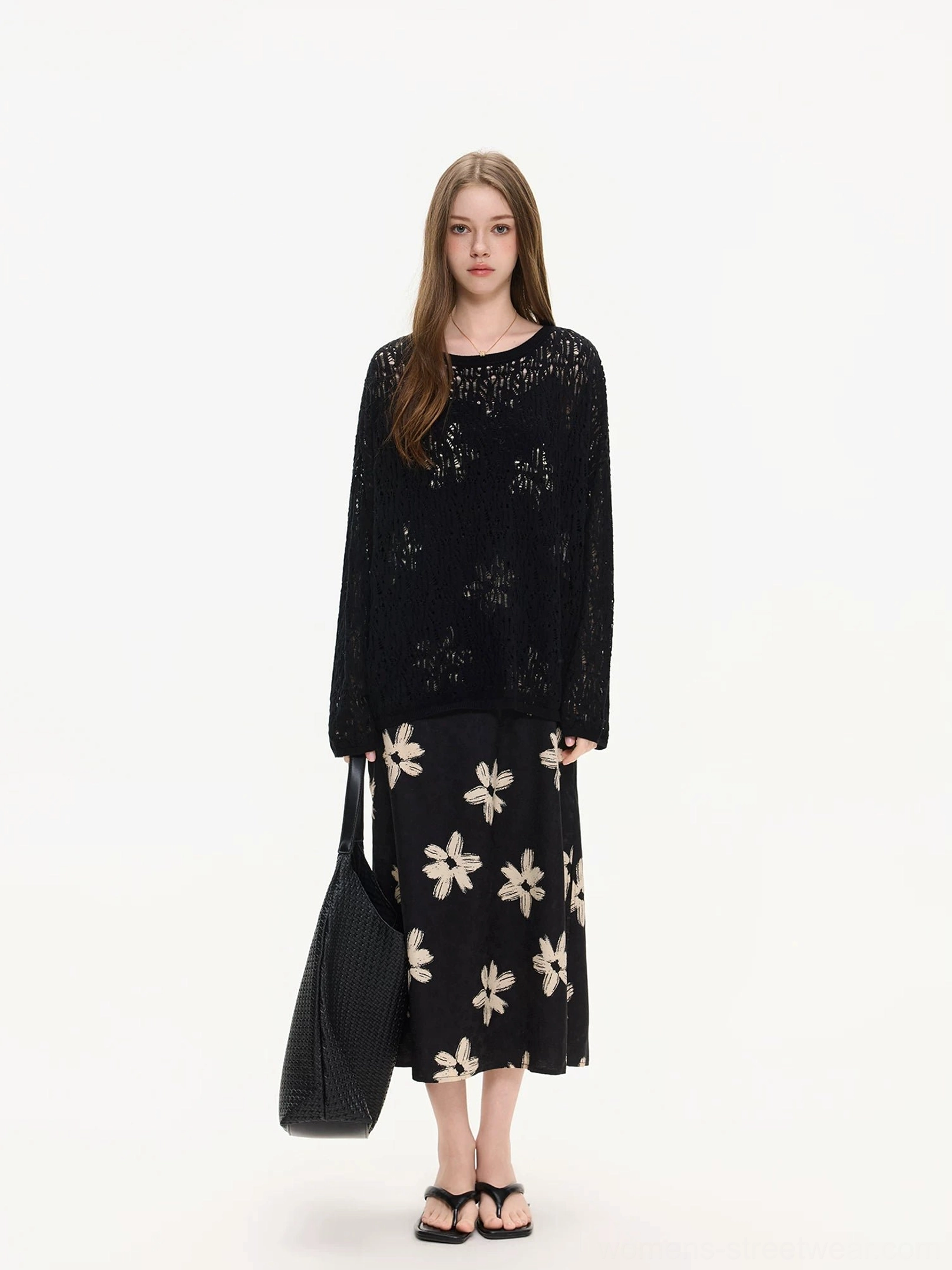 Black open knit top styled with a matching black and ivory floral midi skirt for a layered Korean streetwear outfit