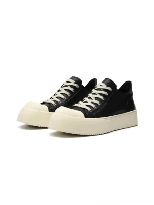 Black Oreo low-top platform leather sneakers with off-white rubber toe cap and thick contrast sole shown in side profile