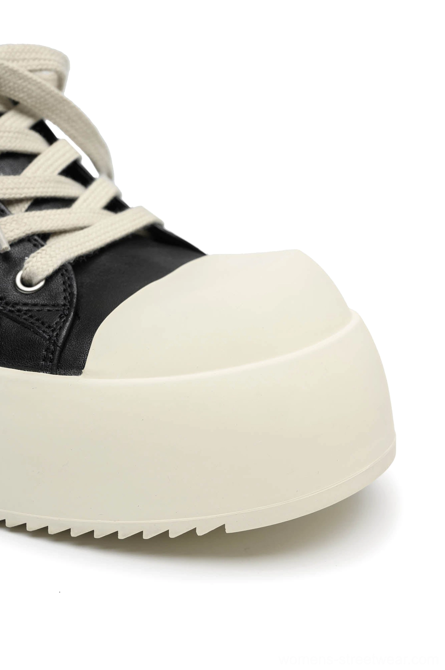 Black Oreo platform sneakers highlighting the clean low-top shape, lace-up front, and contrasting rubber toe cap