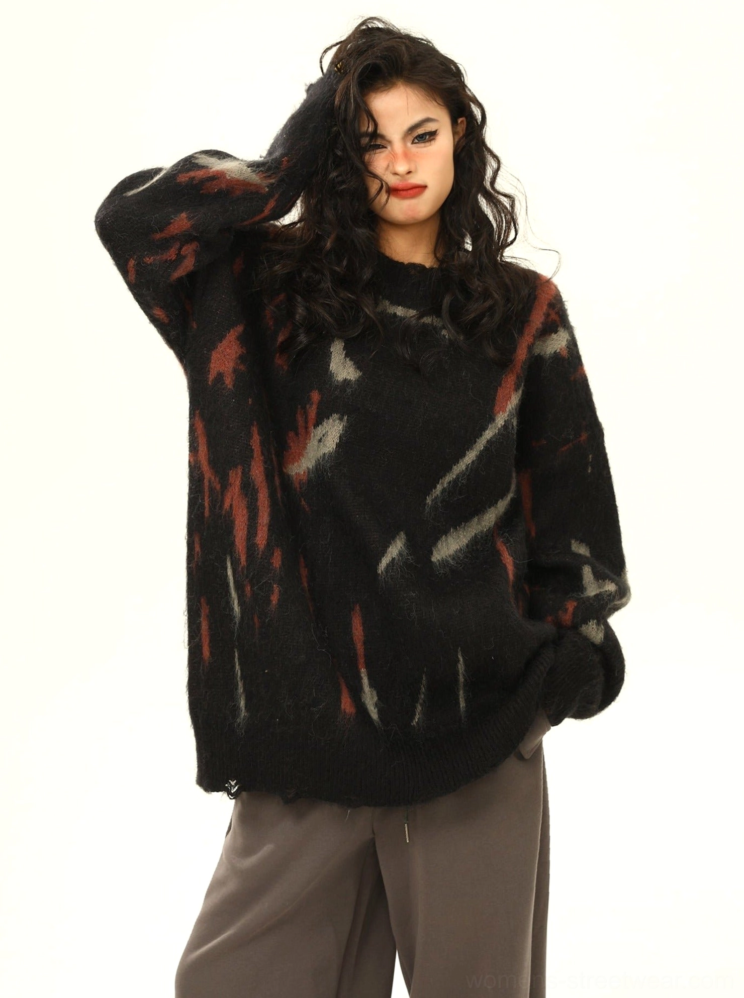 Black oversized abstract pattern sweater with crew neckline distressed hem and reddish brown graphic print