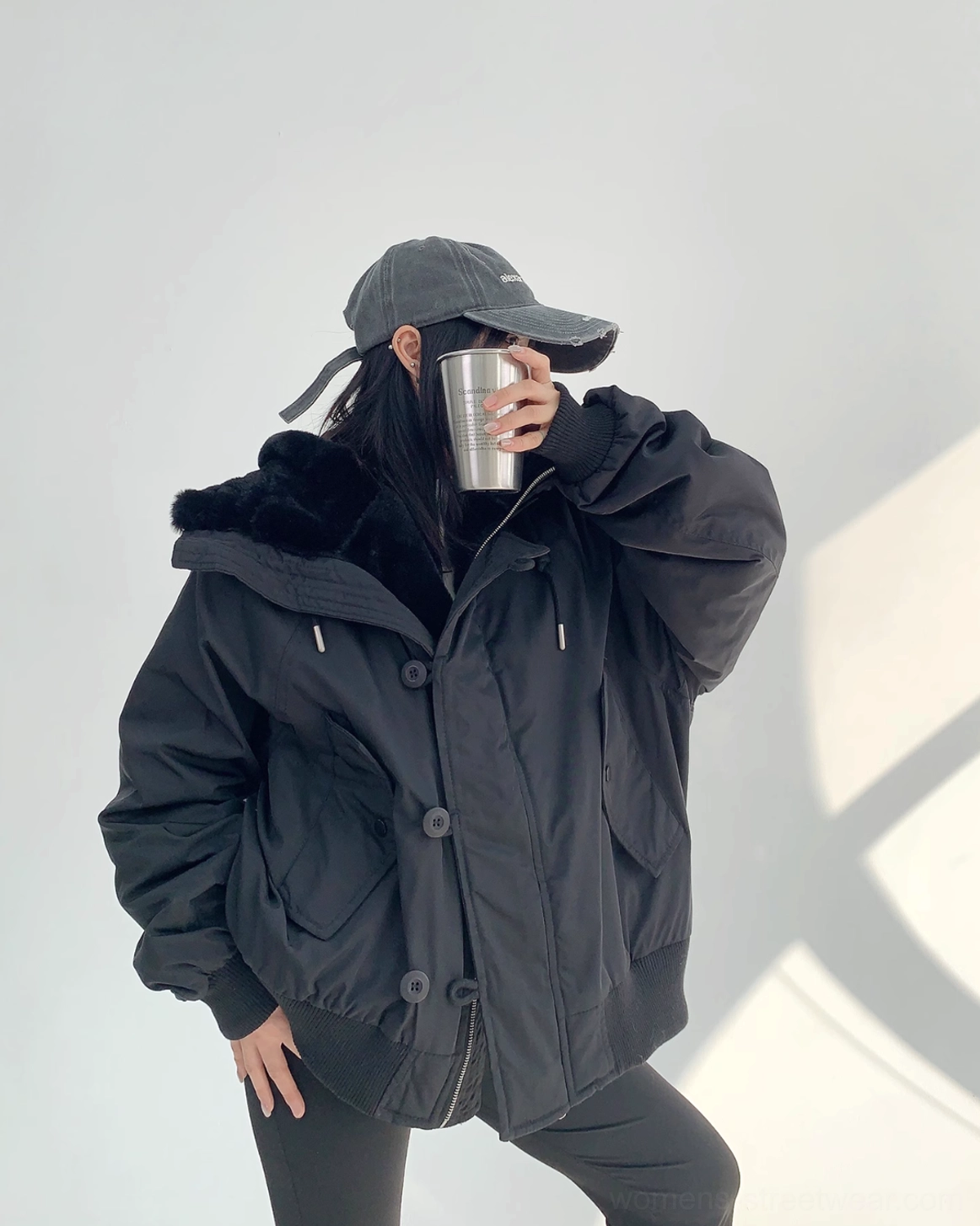 Black oversized aviator jacket featuring a warm sherpa lining, concealed zipper, button placket, and utility pocket styling
