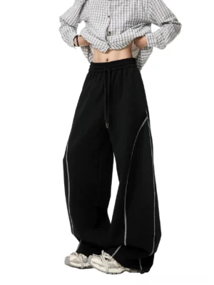 Black oversized balloon sweatpants for women with baggy wide leg fit, adjustable drawstring waist, contrast topstitching, and Korean streetwear styling