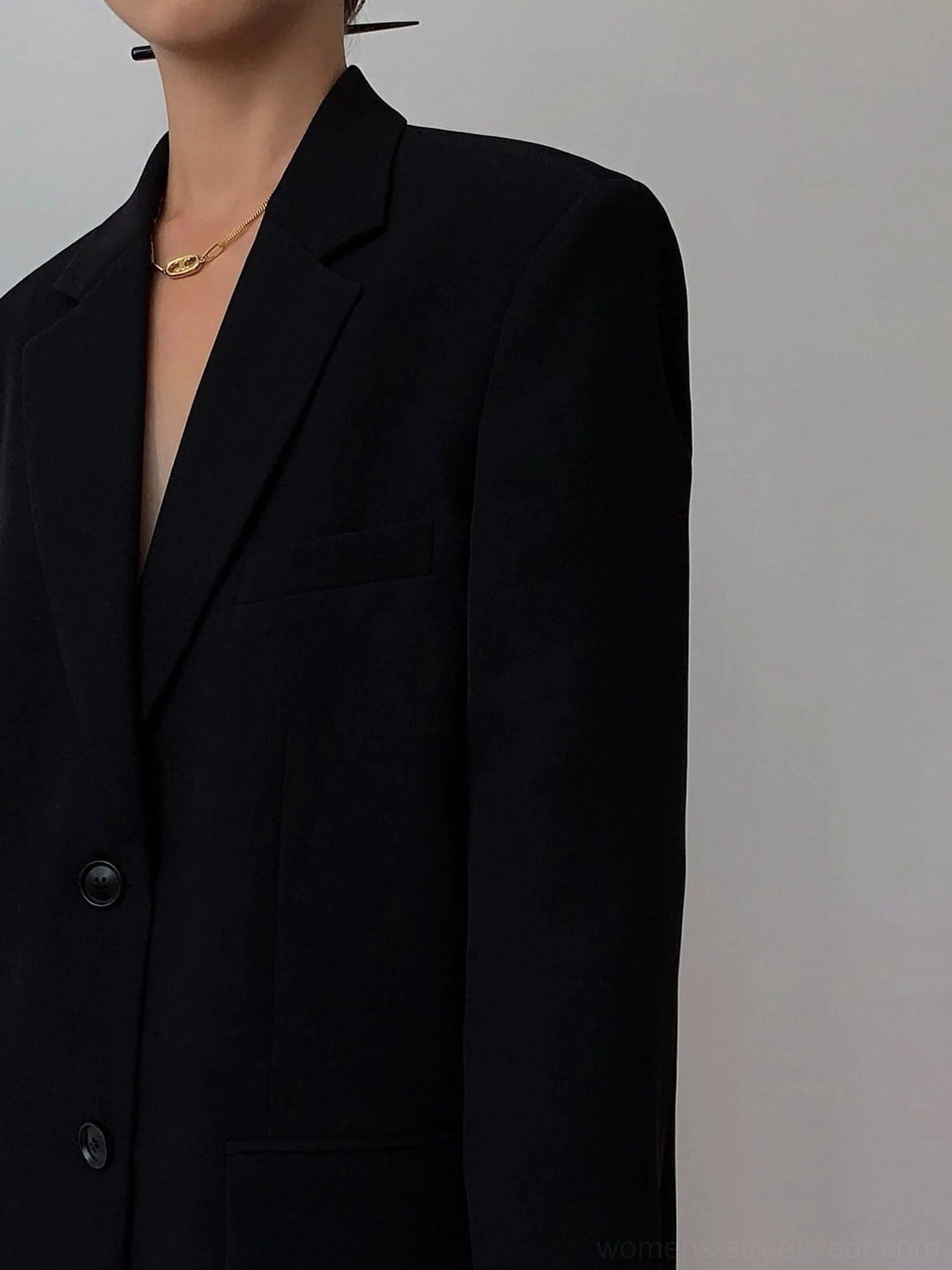 Black oversized blazer close-up notched lapel double-breasted buttons inner chest pocket detail
