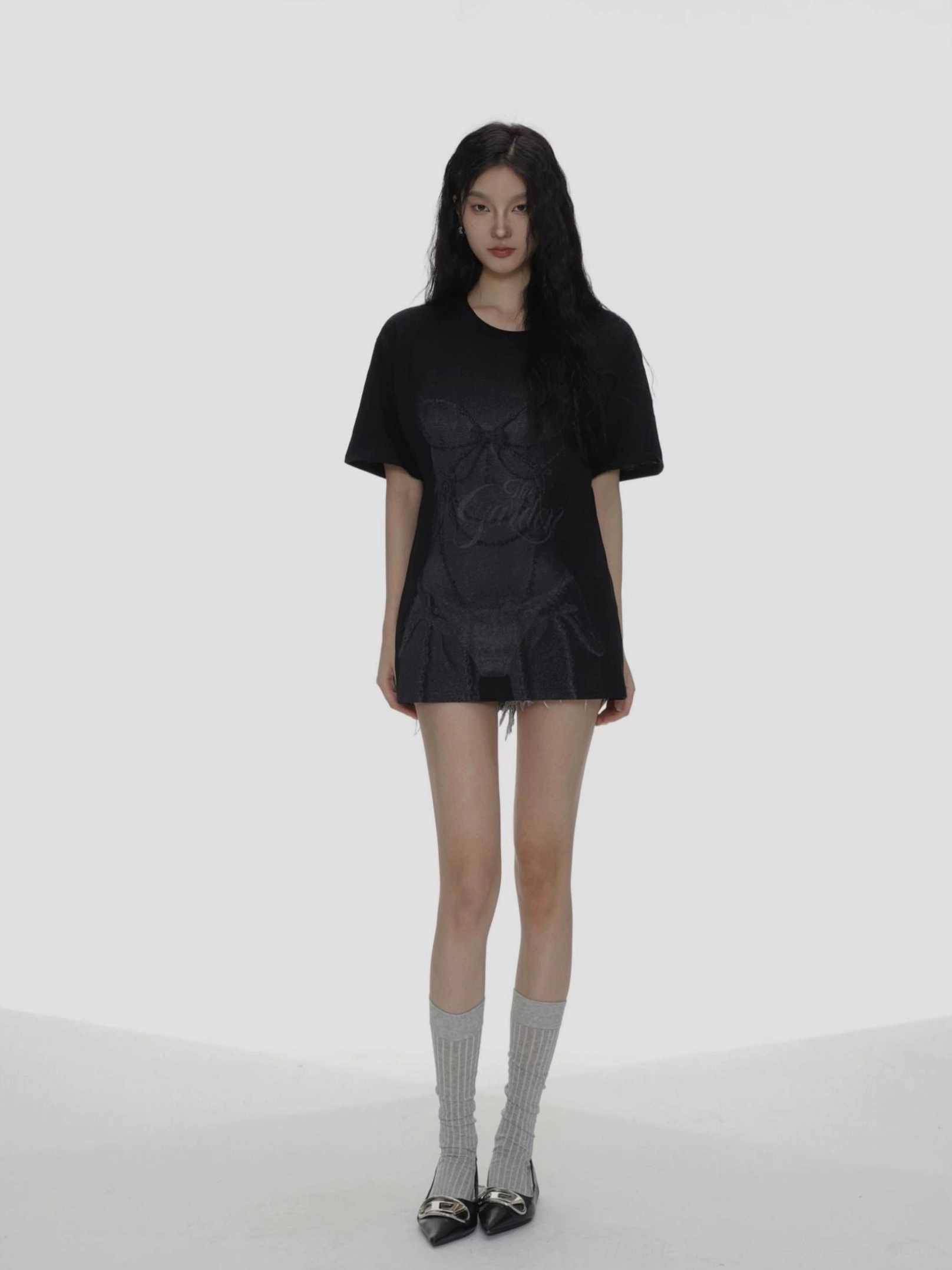 Black oversized bow graphic T-shirt front view styled with long socks and leather loafers