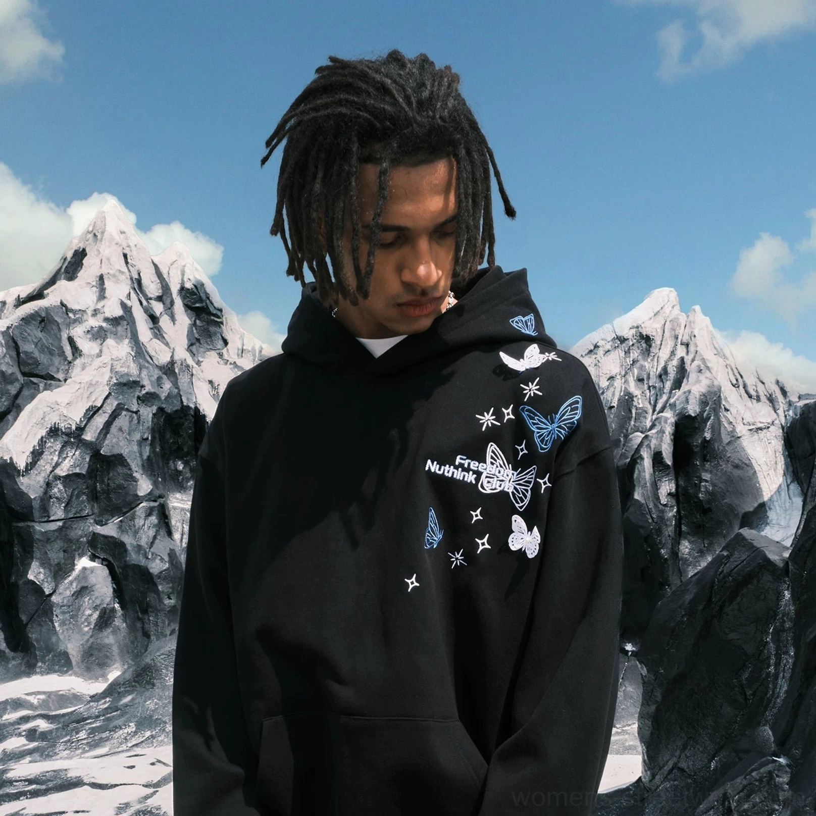 Front three-quarter view of a Black oversized streetwear hoodie with detailed butterfly and star embroidery