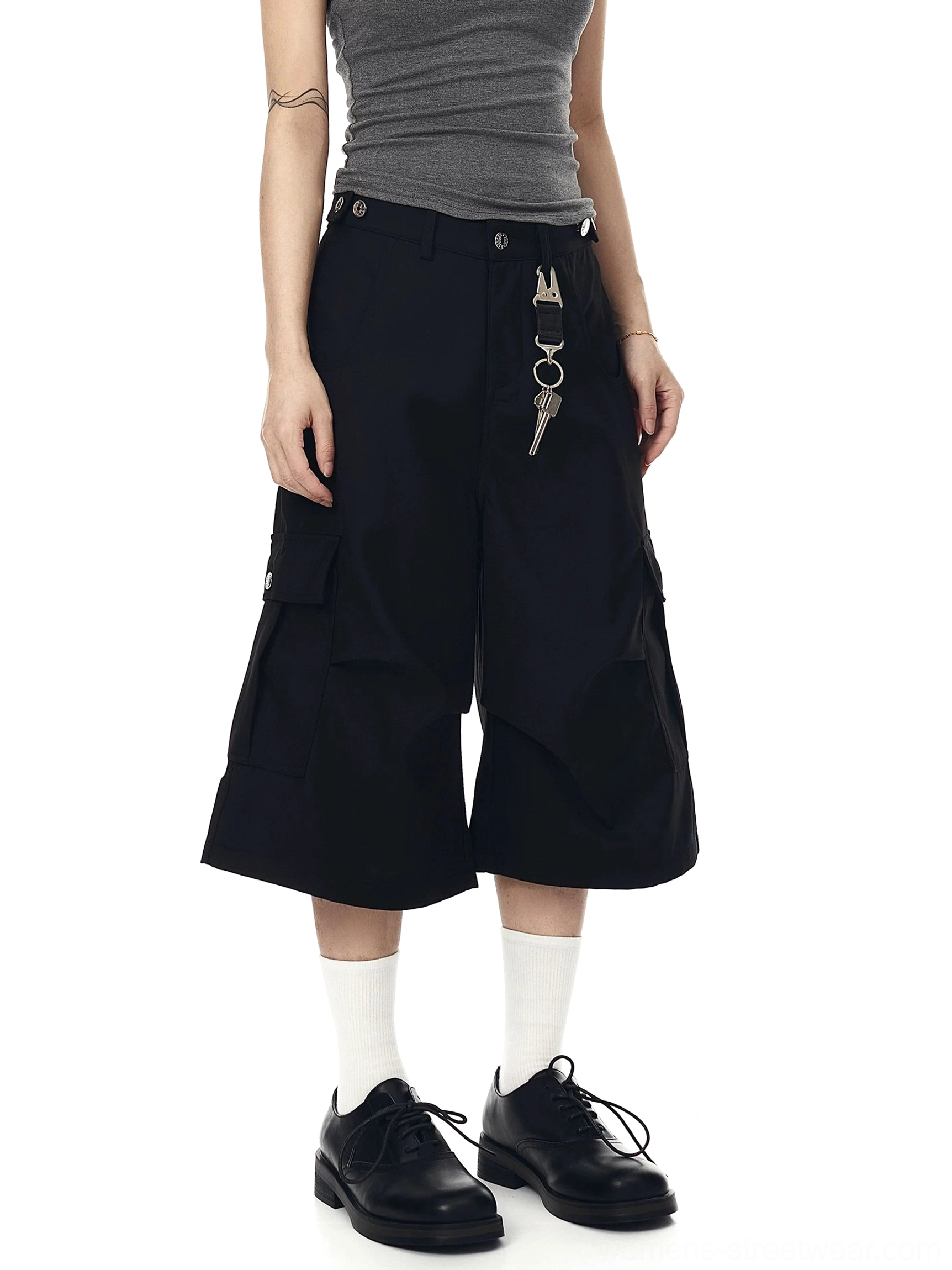Front view of black oversized cargo culotte shorts with wide cropped legs, flap cargo pockets, and Y2K Seoul streetwear styling