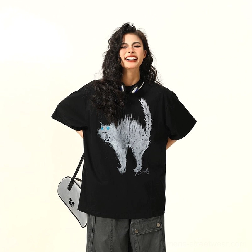 Black oversized cat graphic streetwear tee featuring a fierce sketch-style cat illustration, electric blue eyes, and relaxed short sleeves