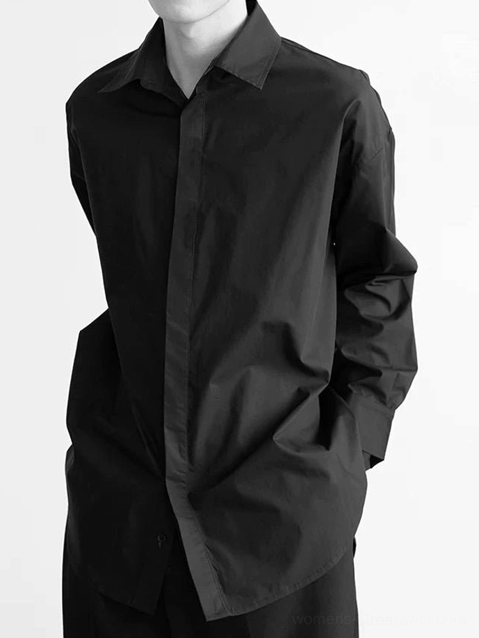 Black oversized cotton poplin shirt with pointed collar and concealed front placket three-quarter view