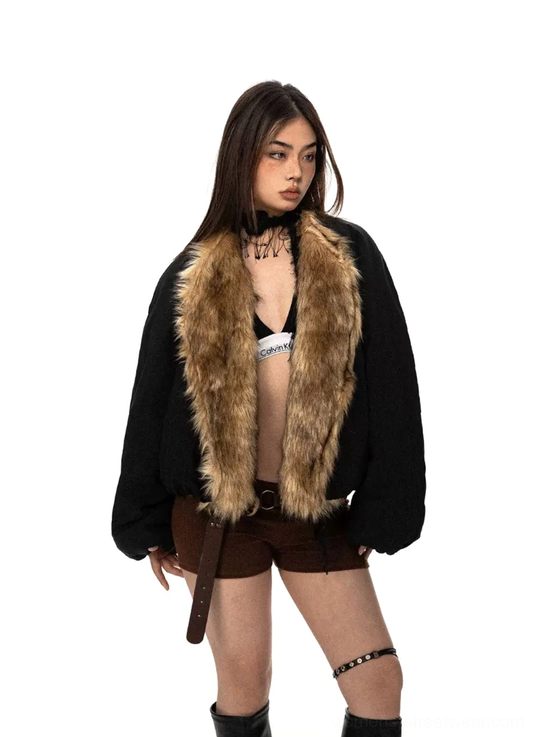 Black oversized faux fur collar cropped flight jacket front view styled with brown shorts and black knee high boots