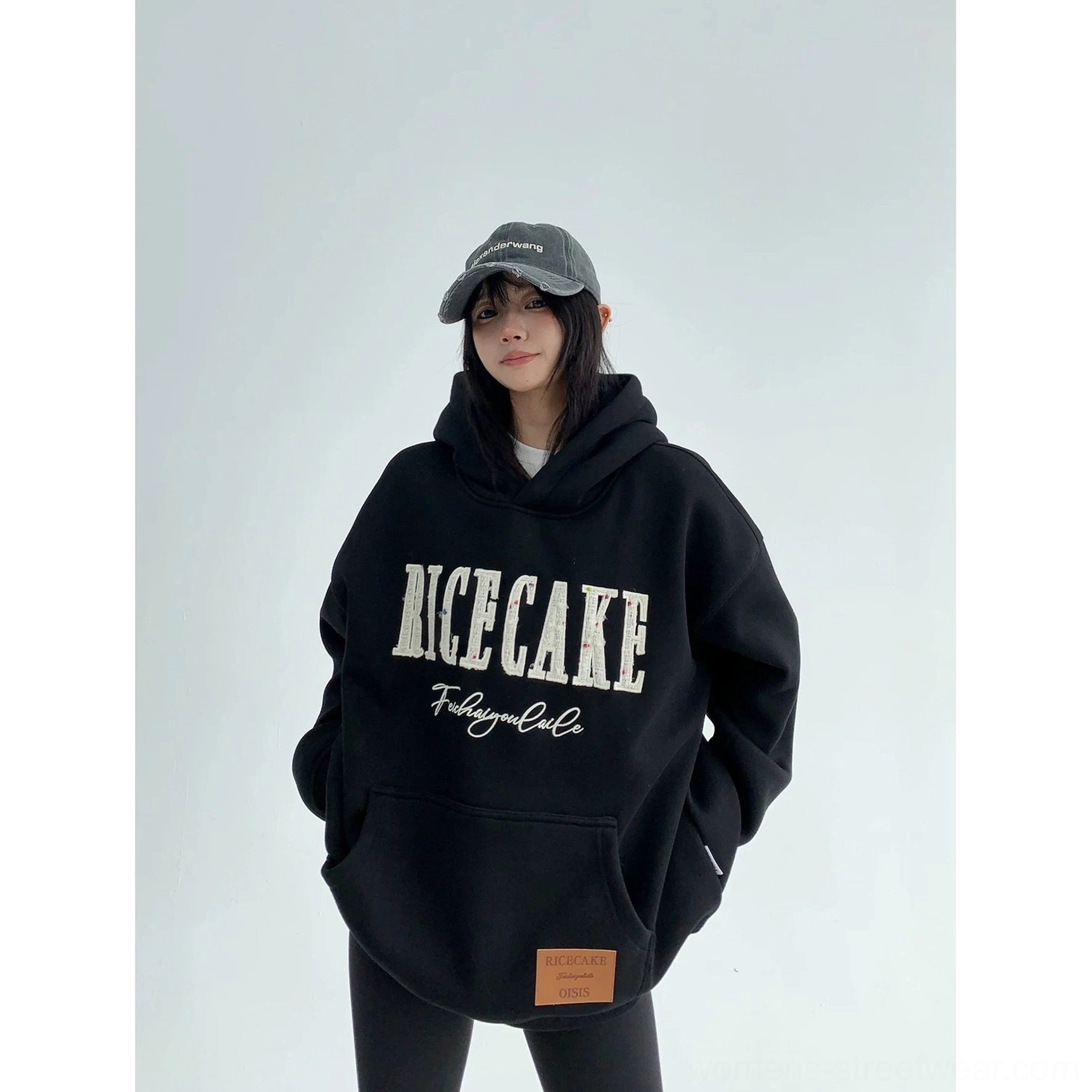 Black oversized graphic hoodie in thick cotton fleece with relaxed drop-shoulder fit and bold varsity-inspired front design