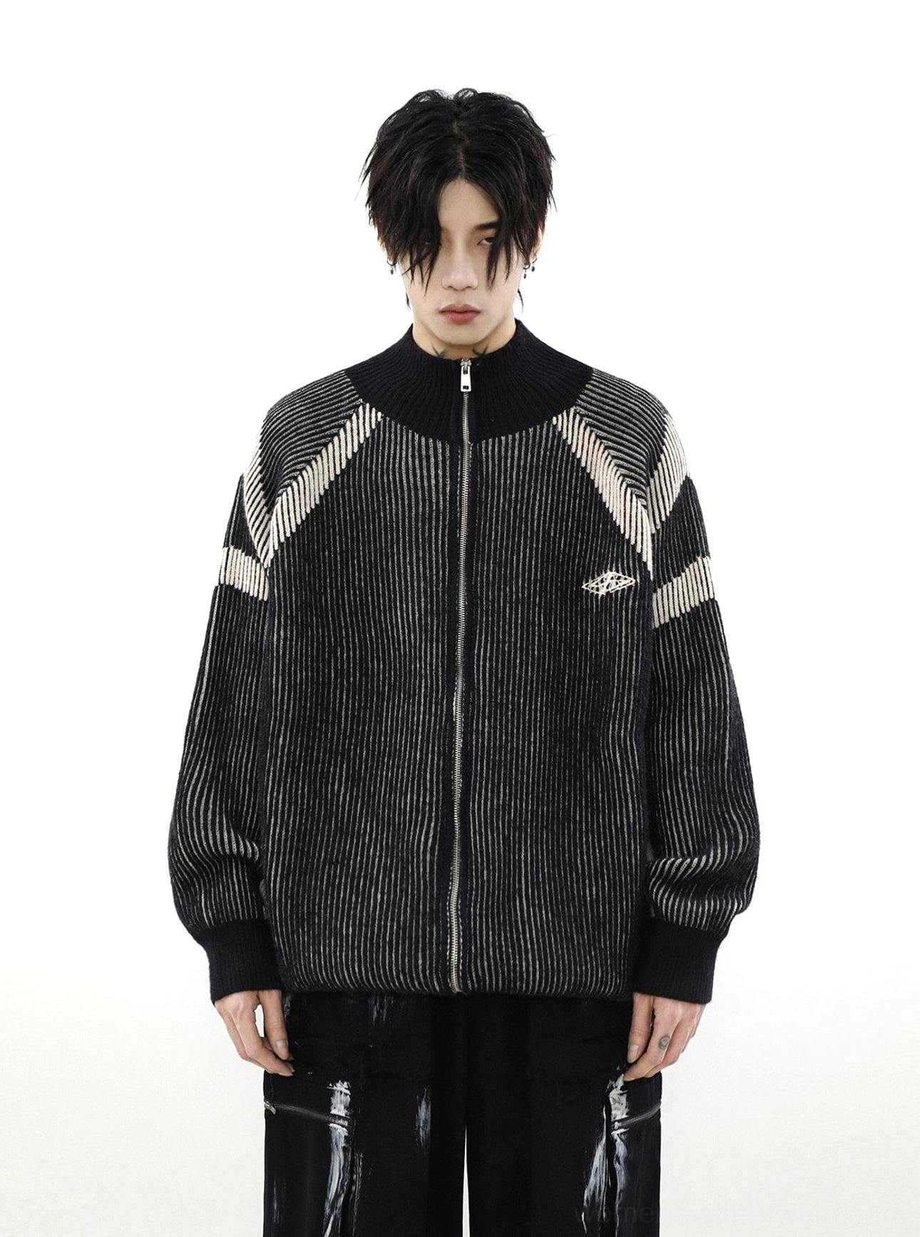 Front view of black oversized high-neck knit cardigan featuring full zipper closure, contrast shoulder stripes, and stand collar