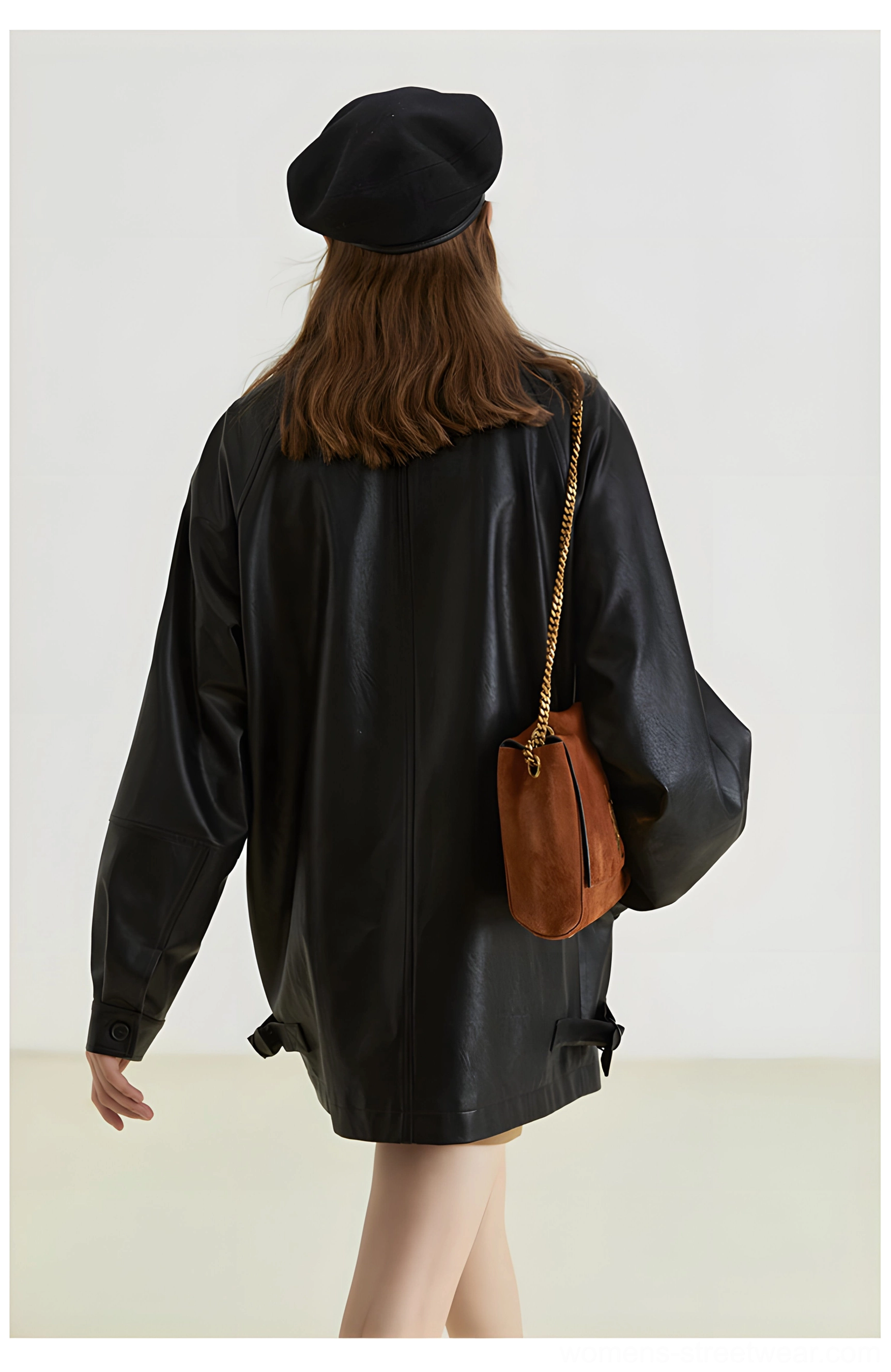 Back full body view of black oversized PU leather moto jacket with smooth back panel and adjustable side hem tabs