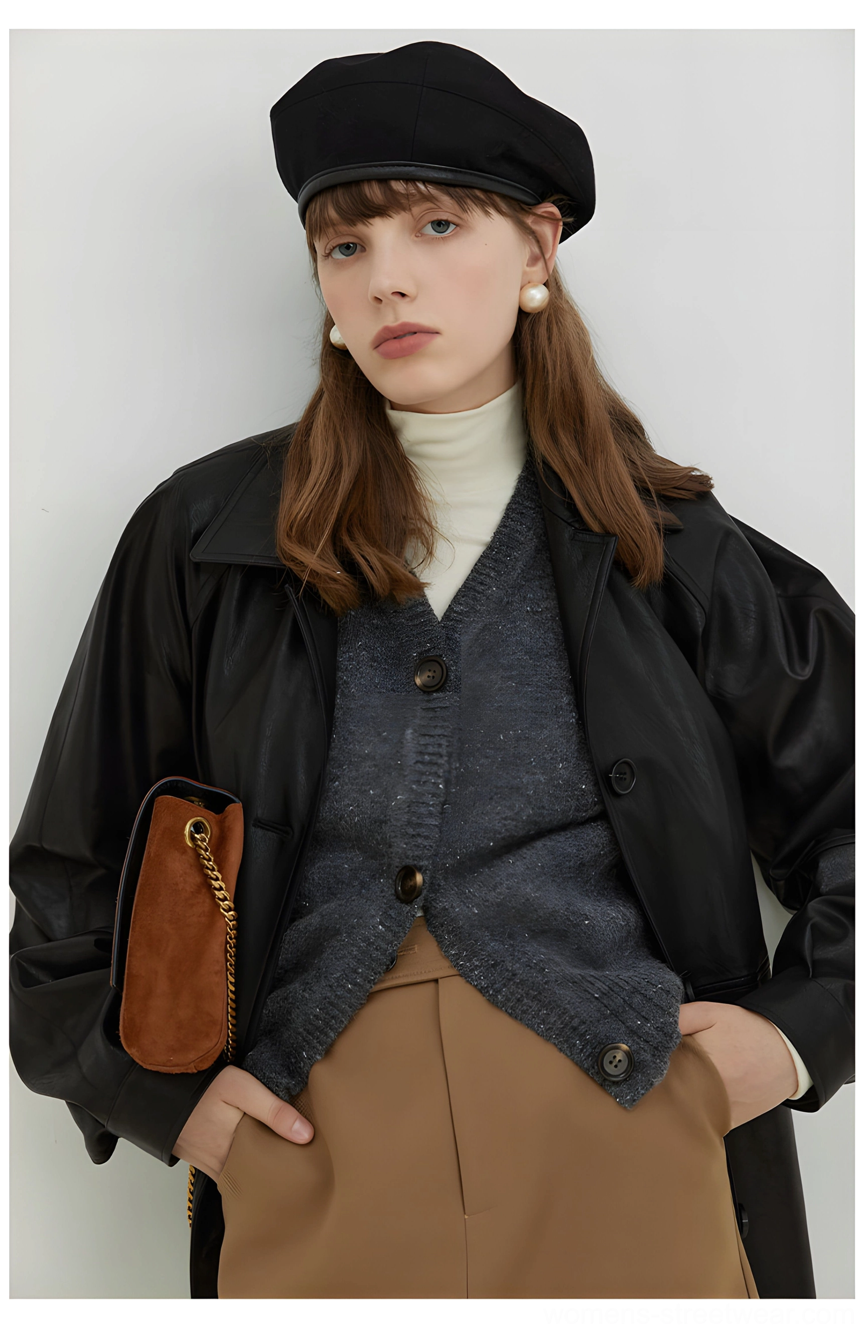 Close front full body view of a black oversized PU leather moto jacket with button closure and relaxed streetwear fit
