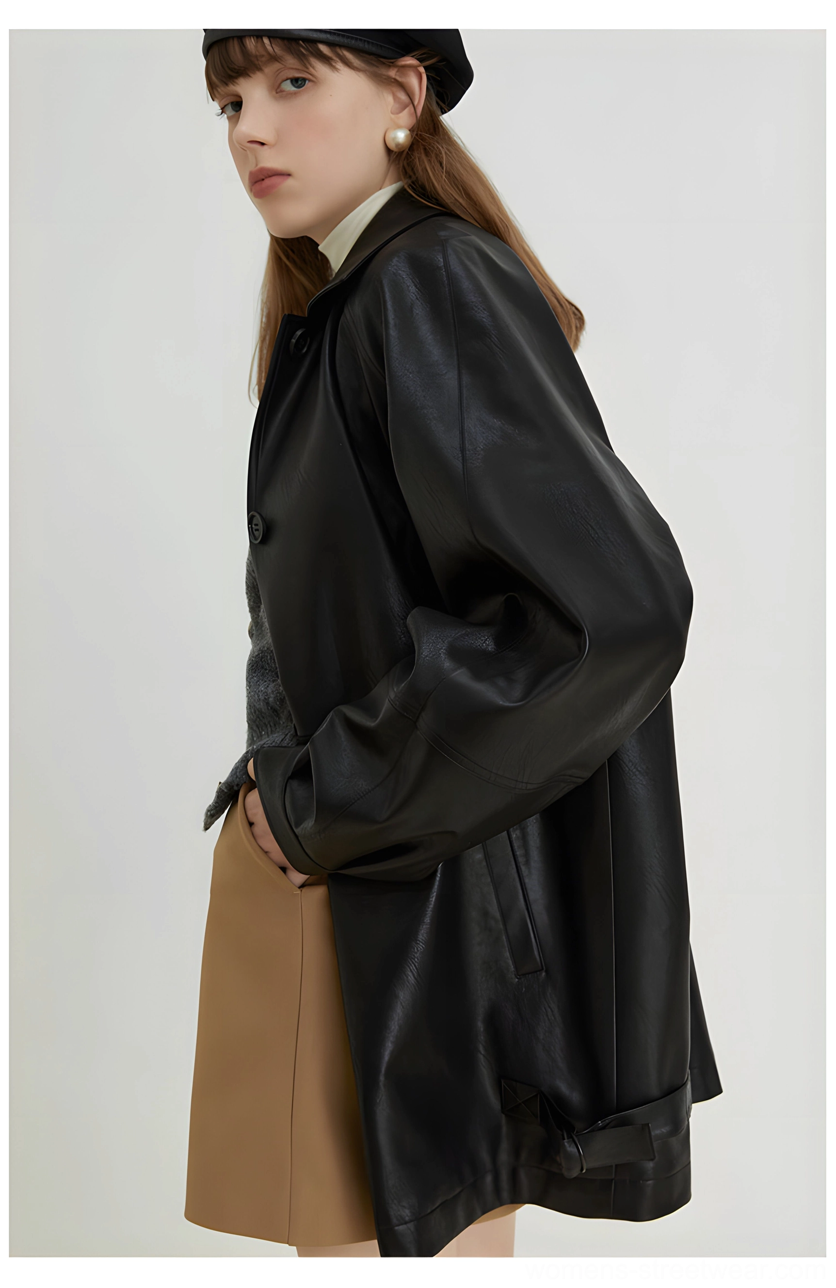 Side view of black oversized PU leather moto jacket showing soft drape utility pocket and adjustable side hem buckle