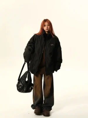 Black oversized stand-collar quilted puffer bomber jacket with embroidered chest detail styled in a full-body Korean streetwear outfit