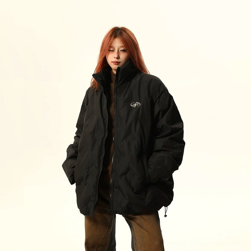 Black oversized quilted puffer bomber jacket with stand collar, chest embroidery, hidden pockets, and adjustable drawstring hem