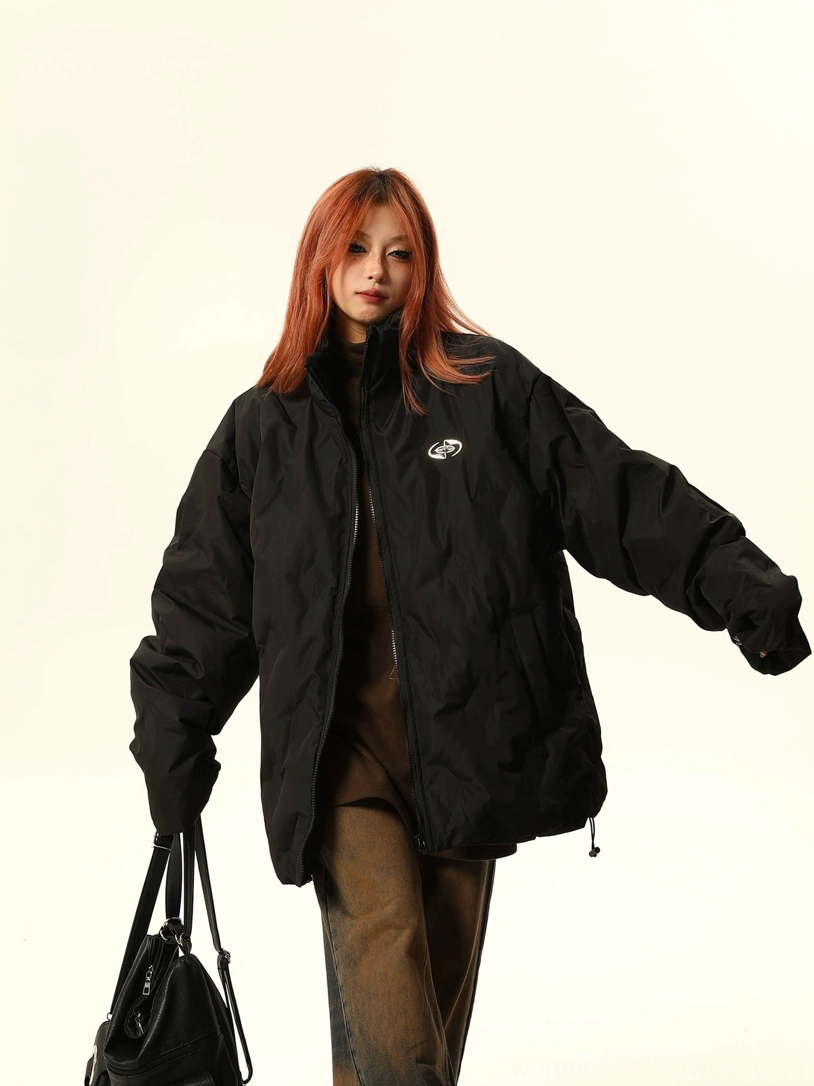 Black oversized quilted puffer jacket with wide sleeves, drawstring hem, hidden pockets, and contemporary Seoul street style