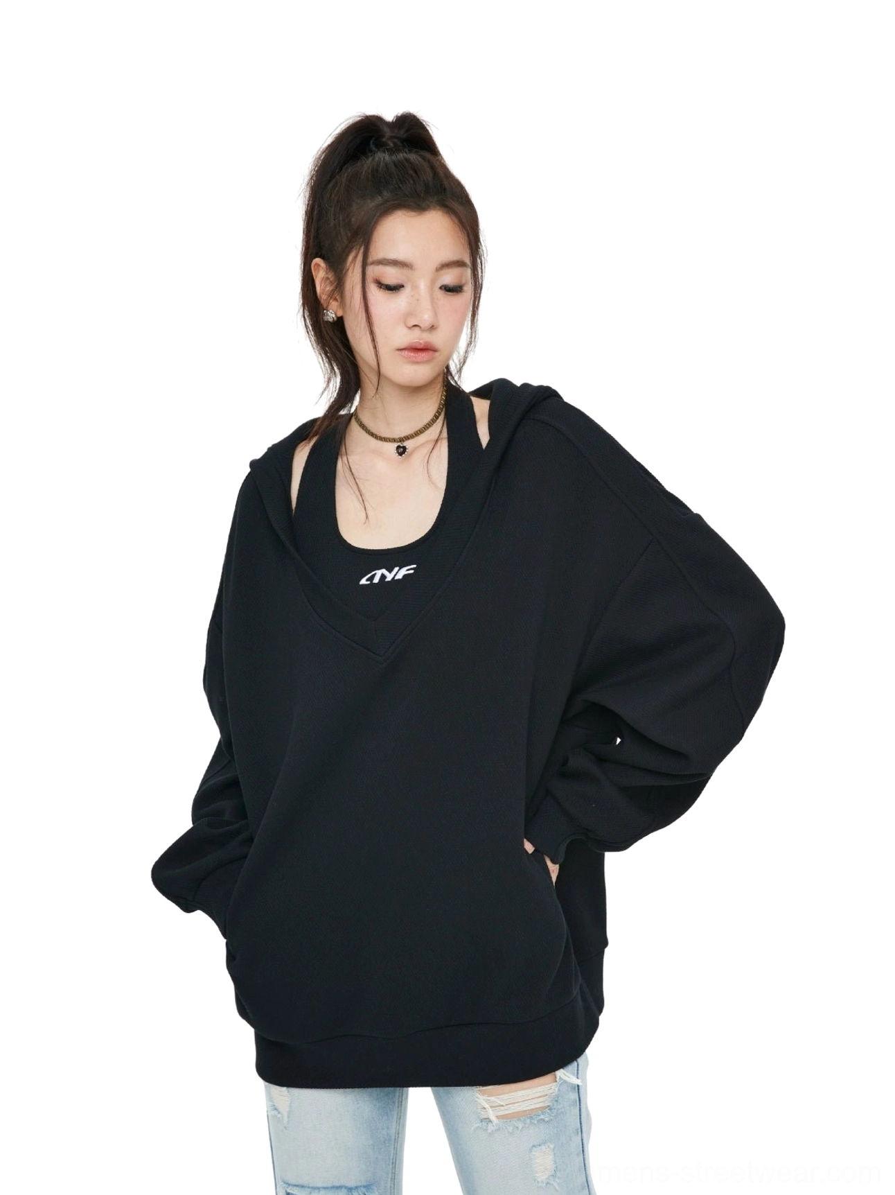 Black oversized V-neck hoodie sweatshirt styled with ripped blue jeans, layered inner halter top, drop shoulders, kangaroo pocket, and relaxed Korean streetwear fit