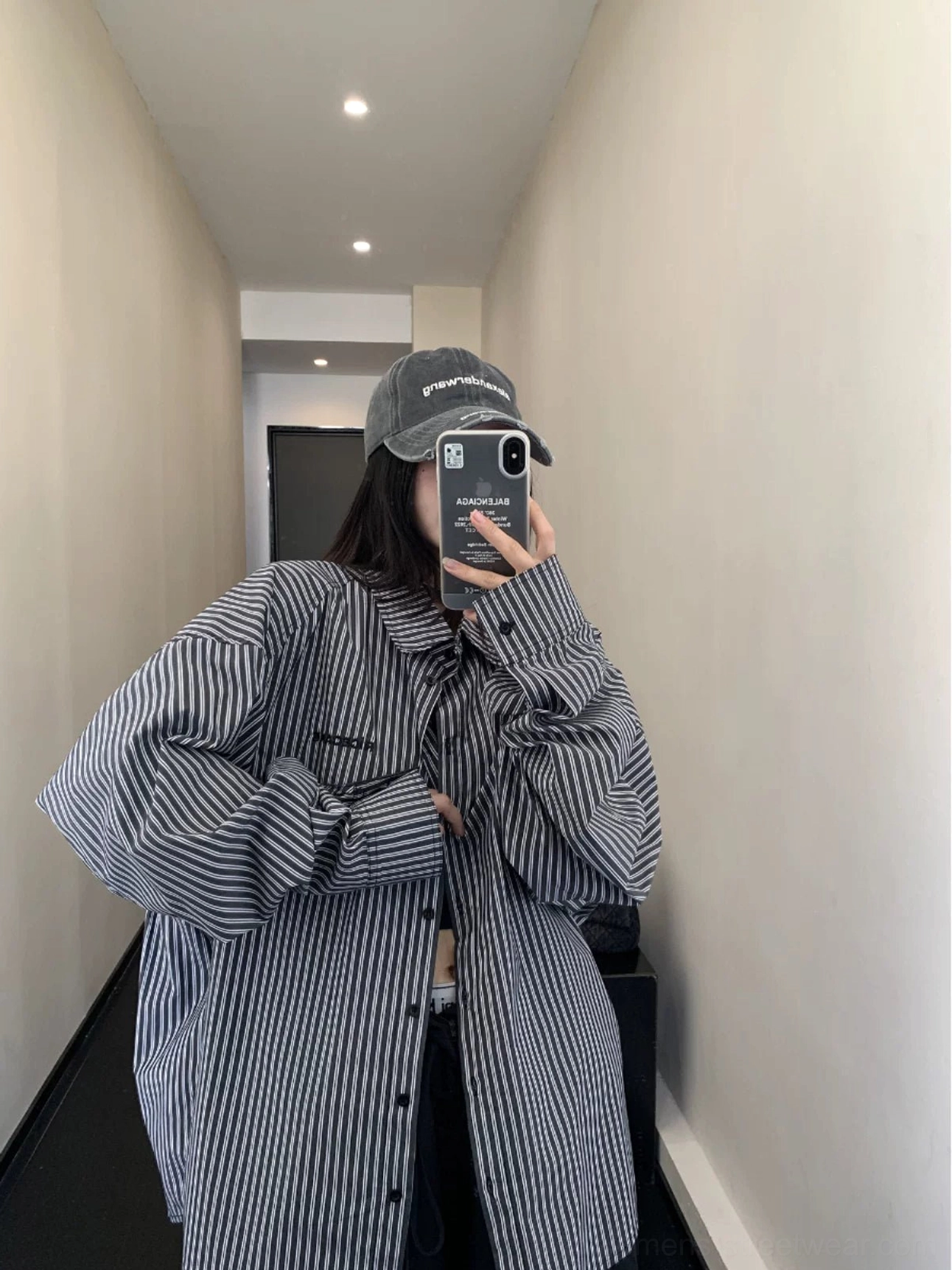 Black oversized striped cotton button-up shirt with chest embroidery and buttoned cuffs in front mirror outfit view
