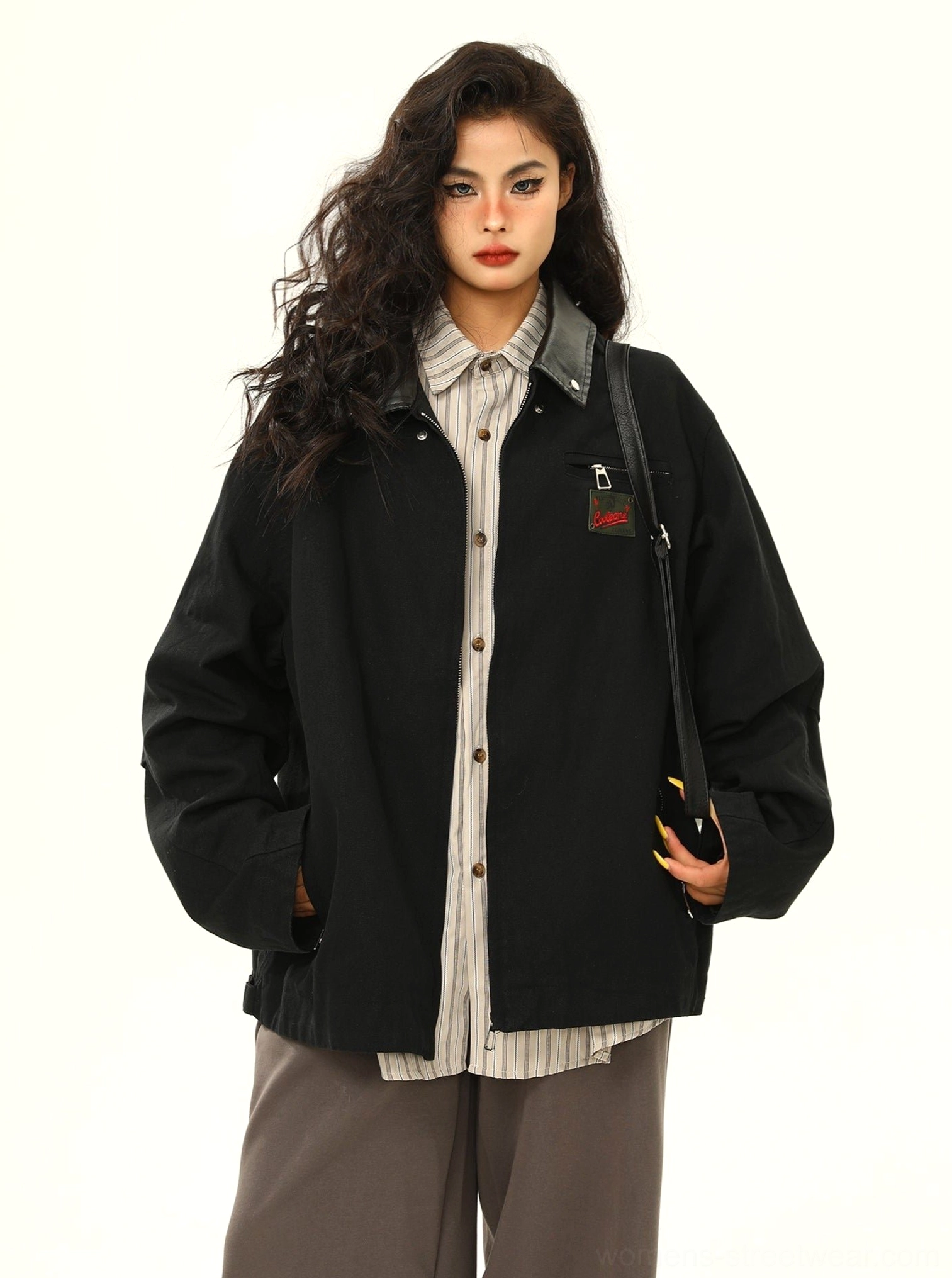 Black oversized vintage cargo work jacket shown from the front with contrast collar, embroidered chest patch, relaxed streetwear fit, and hands-in-pockets styling