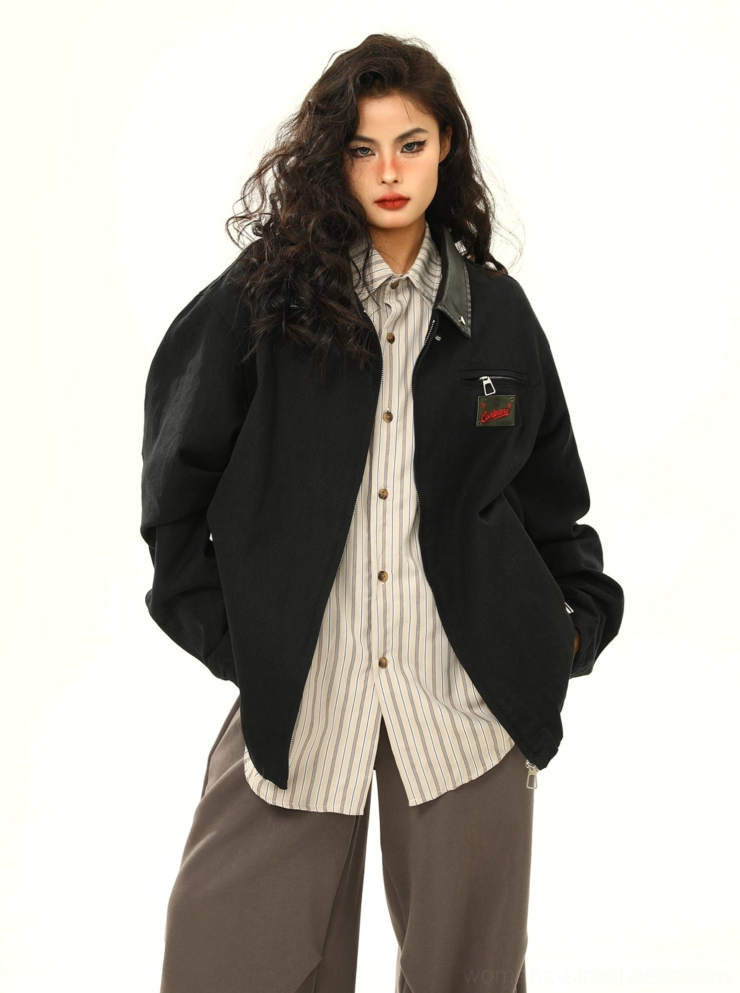 Full-body view of a black oversized vintage work jacket with dropped shoulders, roomy sleeves, layered outfit styling, and casual streetwear silhouette