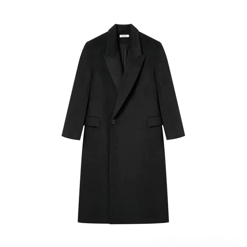 Flat lay view of a black oversized wool peak lapel coat with single-button front and flap side pockets