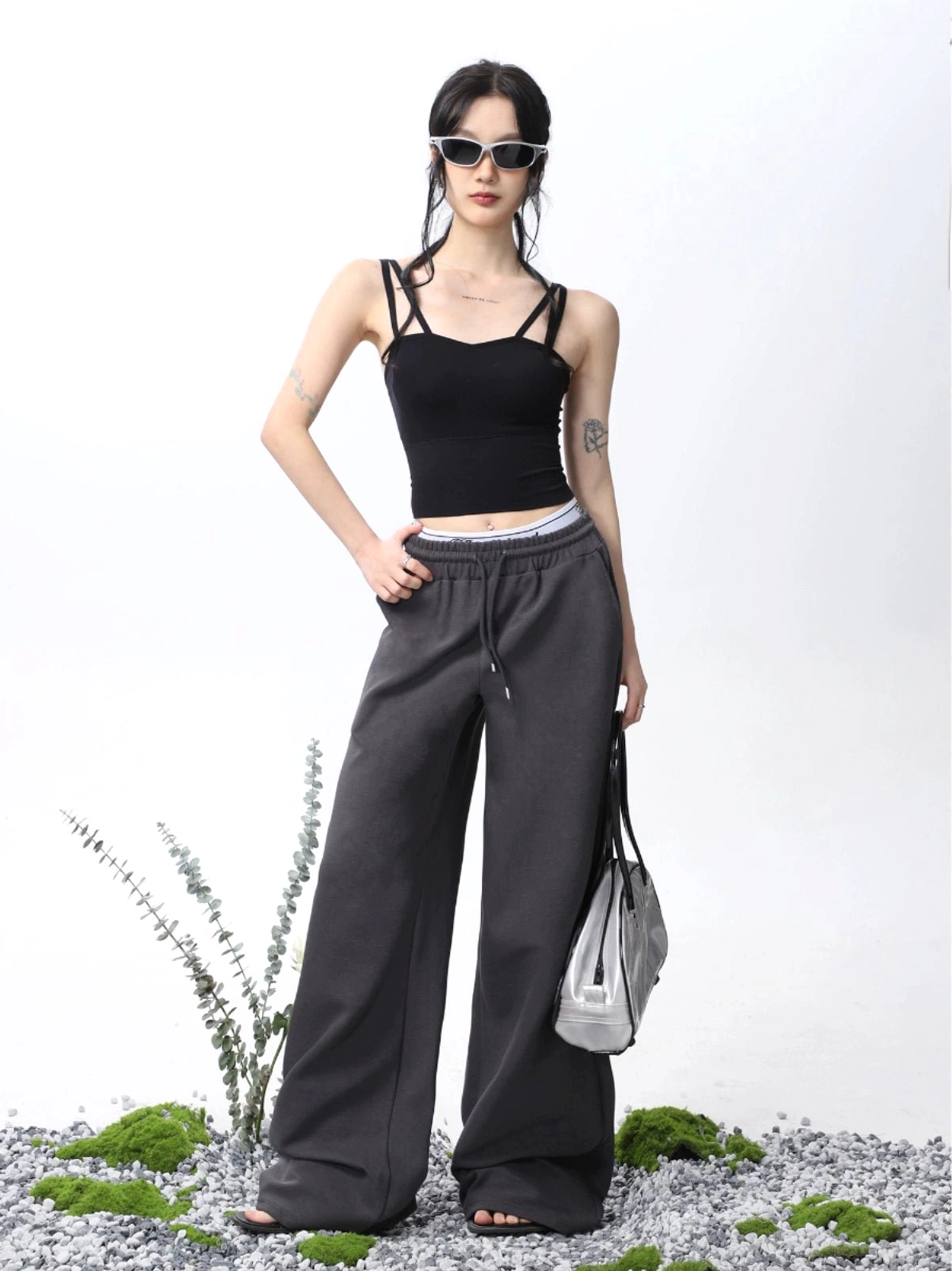 Black padded double spaghetti strap cropped camisole tank top styled with dark gray high waisted wide leg drawstring sweatpants and sunglasses