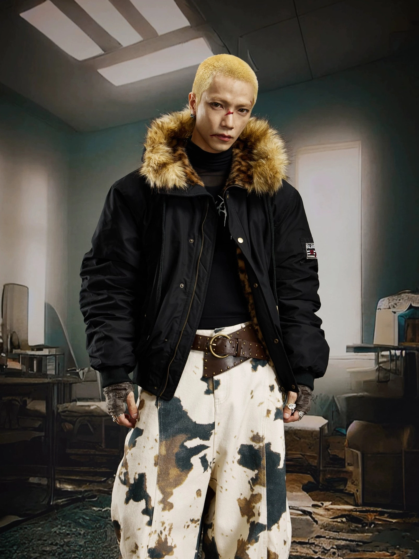 Three-quarter view of a male model wearing an open black padded hooded bomber jacket with brown faux fur trim and utility styling