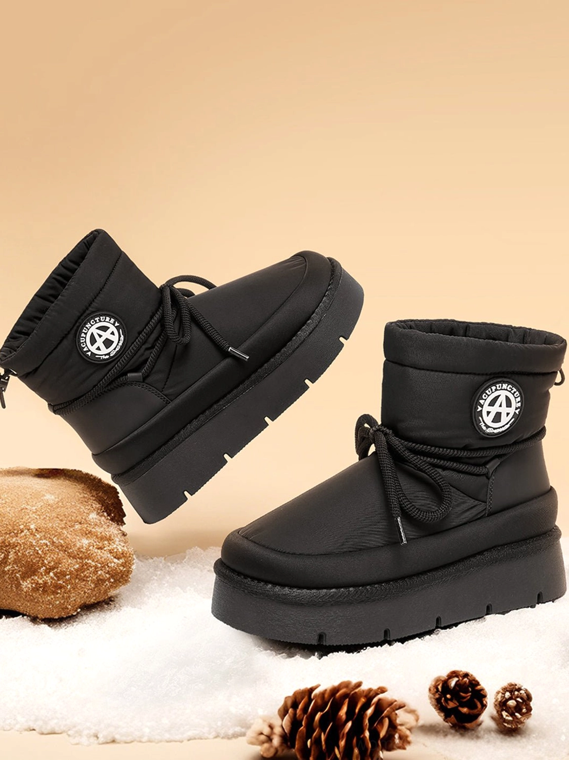 Black padded platform snow boots displayed in front and side profiles highlighting the plush ankle collar and flatform sole