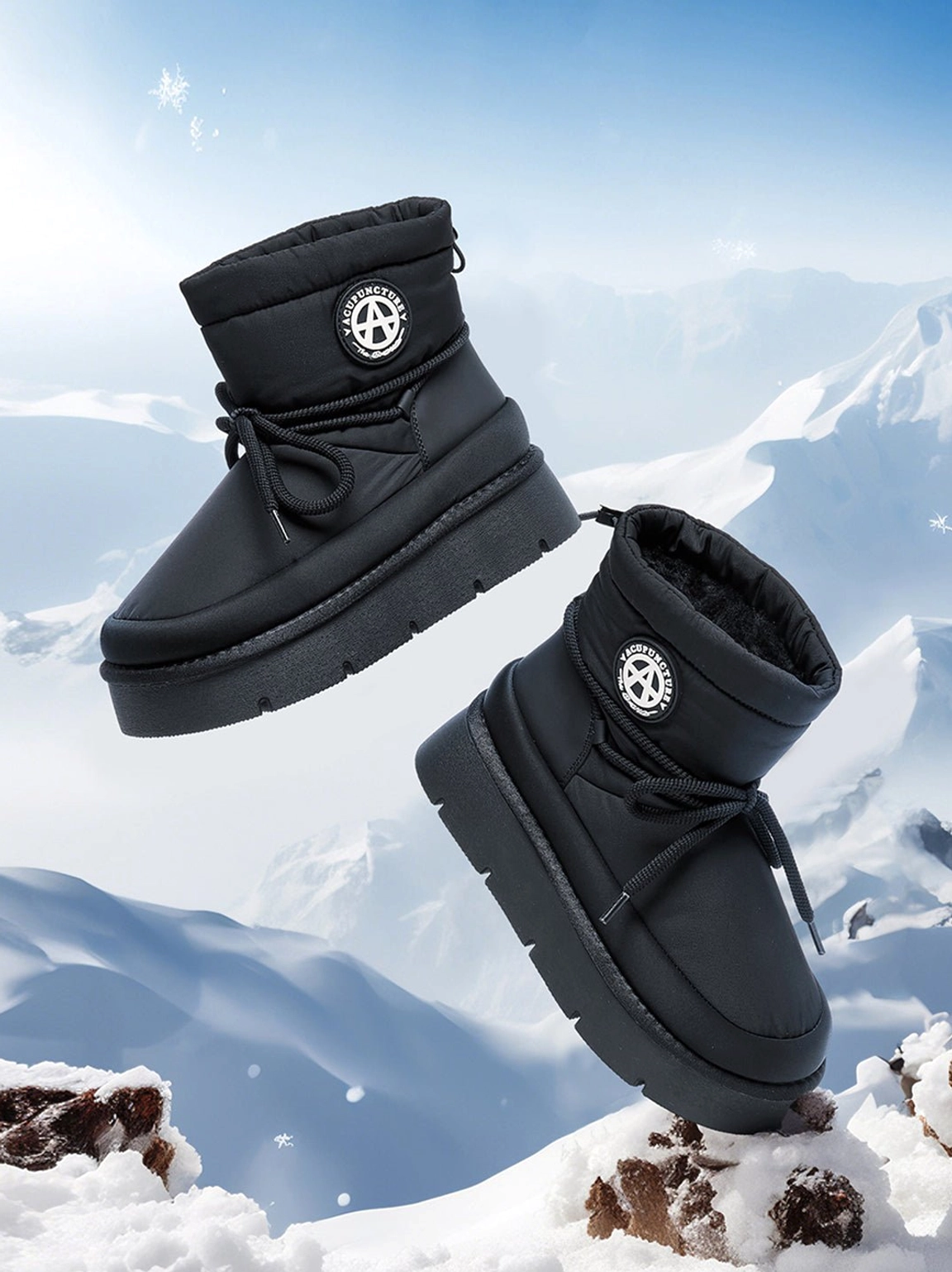 Floating black padded platform snow boots with lace-up closure and thick flatform soles against a winter mountain backdrop