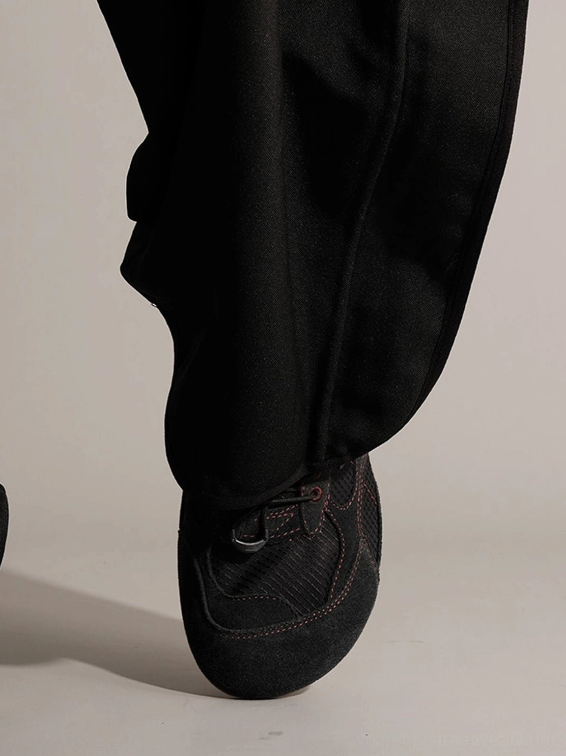 Front view of black paneled nubuck trainers with mesh suede vamp and stitched seams