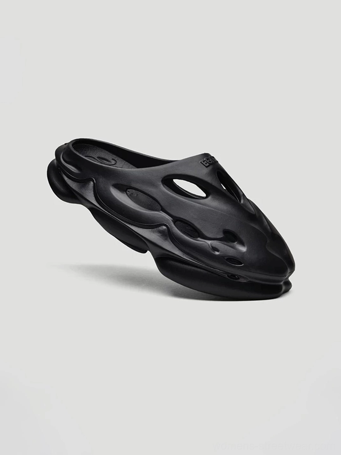 Black Panther black perforated platform clog side view featuring a streamlined open-back mule shape and chunky raised sole