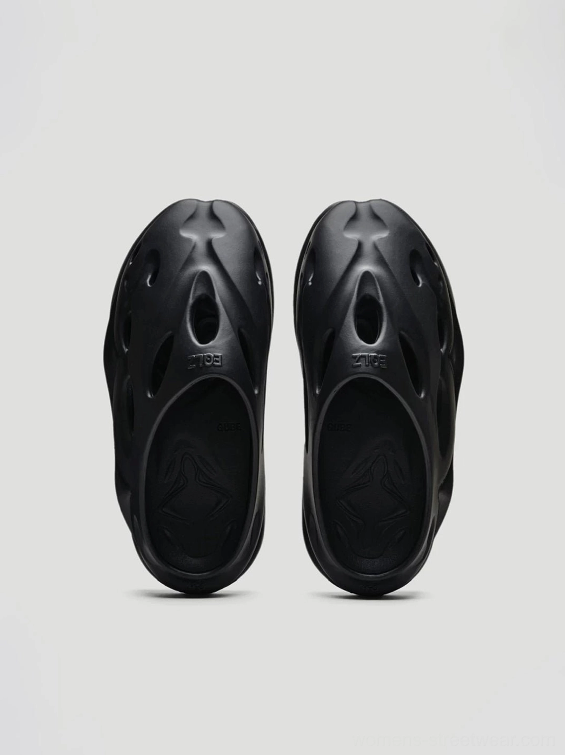 Black Panther black perforated platform clogs rear top view showing open shoe cavity and sculptural slip-on construction