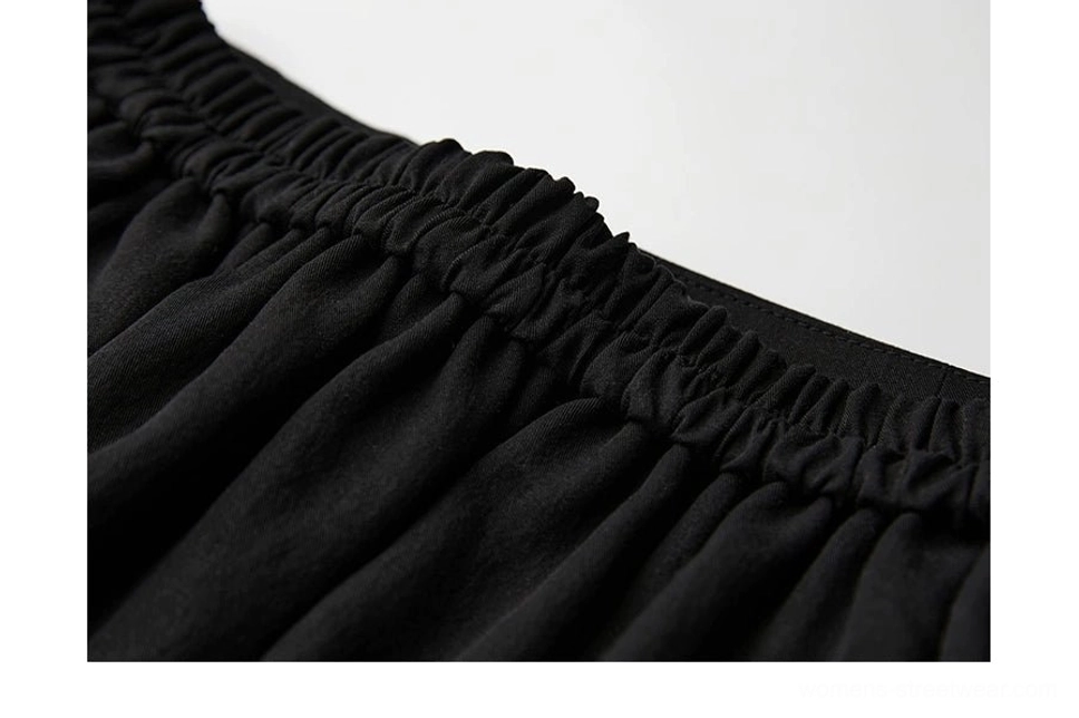 Close-up of ruched elasticated waistband on black patchwork A-line maxi skirt