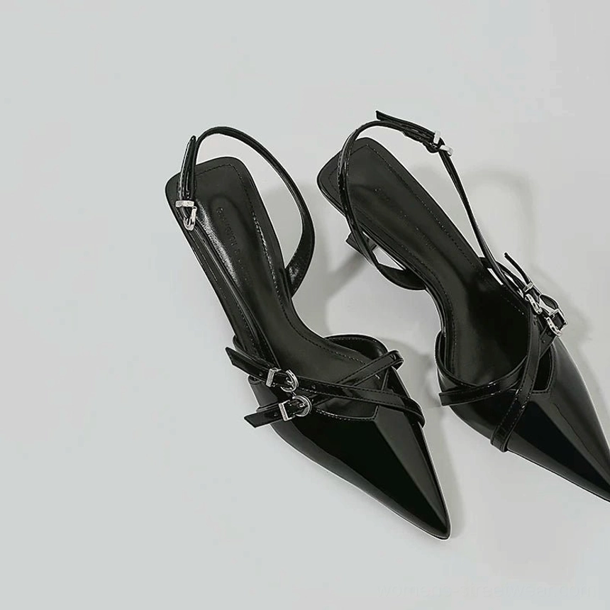 Black pointed toe patent slingback buckle heels pair displayed from above with silver hardware and low kitten heels