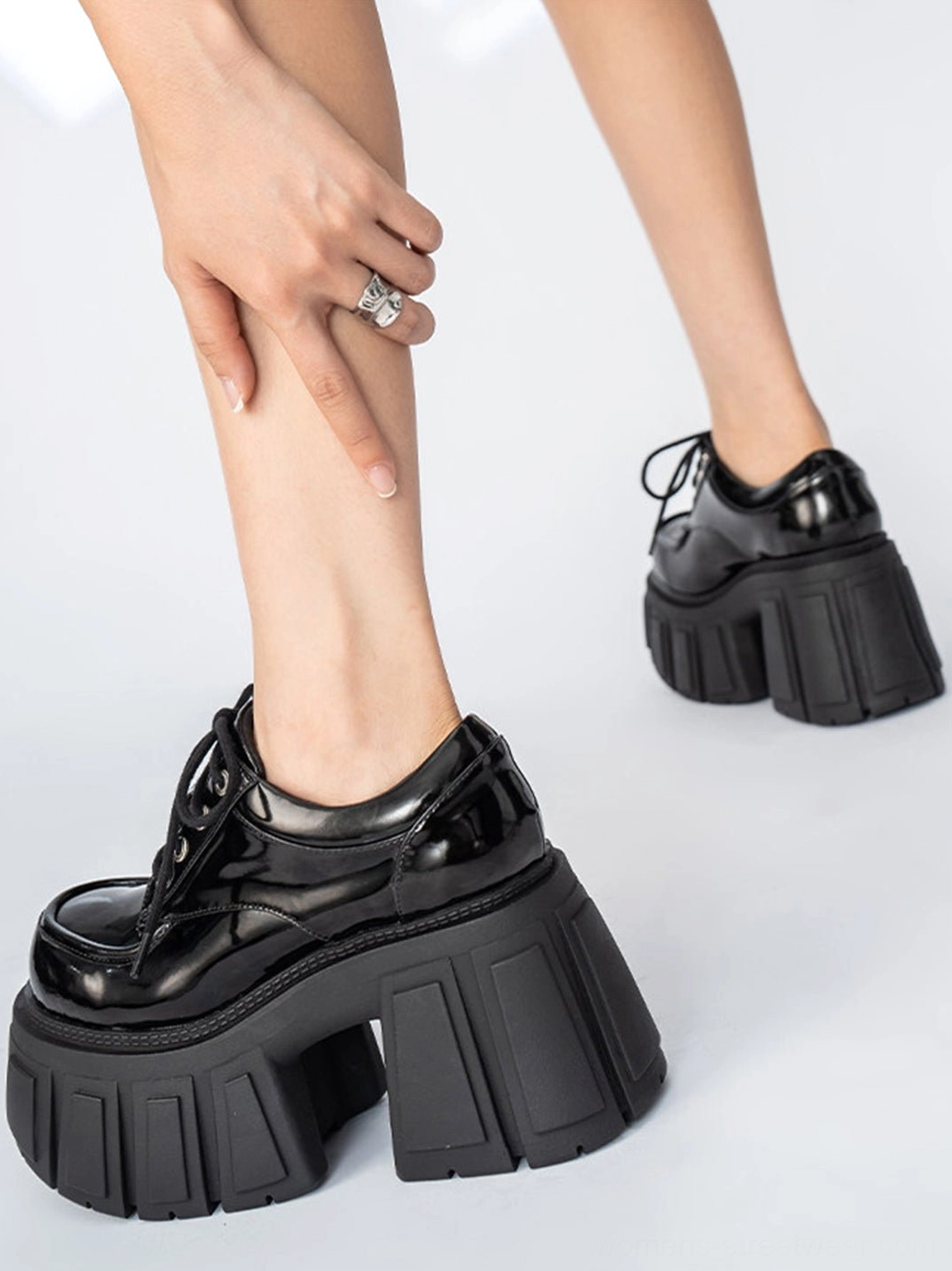 Front and side view of black patent chunky platform derby shoes with classic Oxford lace-up design and ridged sole