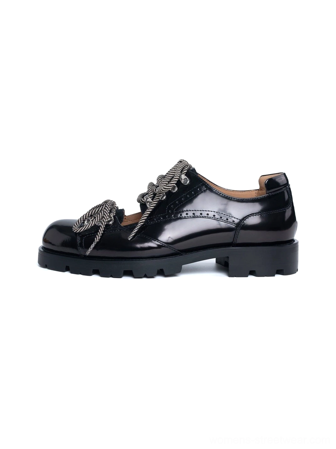 Glossy black patent-look cutout workwear derby shoes with brogue perforations, braided gray laces, metal eyelets, and chunky lug rubber soles on a white background