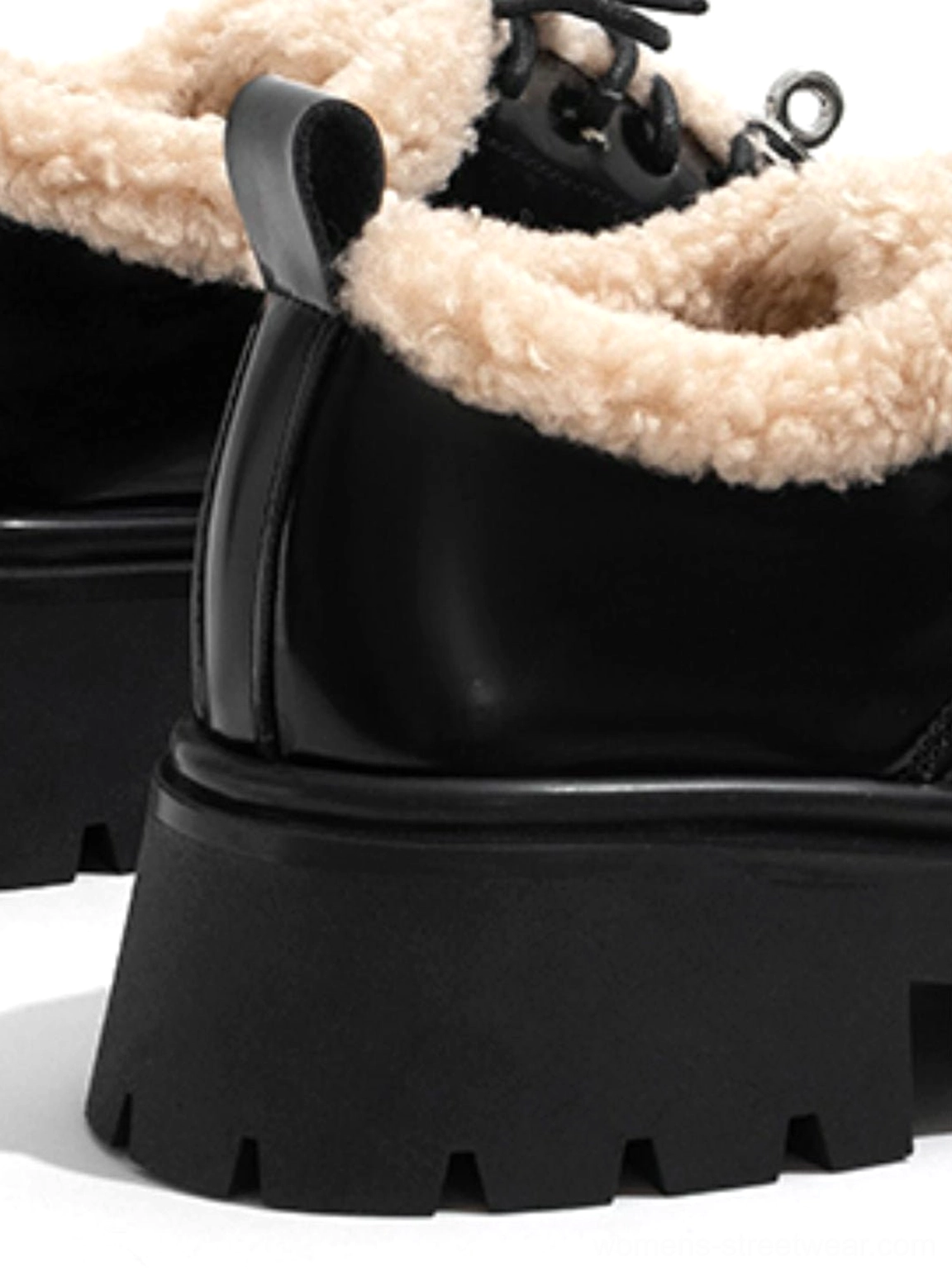 Close-up rear-side view of black patent fleece-collar Oxford shoes highlighting the chunky lug platform sole and plush collar