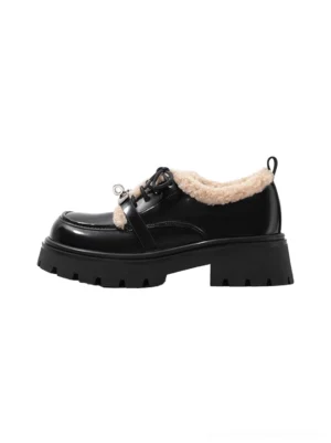 Side view of black patent fleece-collar platform Oxford shoes with beige shearling trim, metal lace buckle, and chunky lug sole
