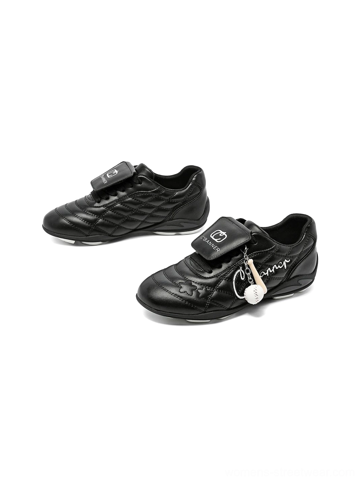 Overhead view of black retro streetwear sneakers featuring foldover tongues quilted panels and side script detail