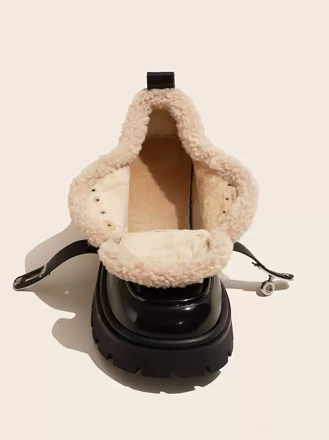 Top-down single view of black patent platform Oxford shoe with exposed beige fleece lining, heel pull tab, and metal charm