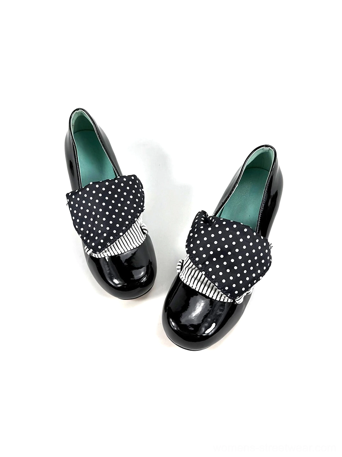 Overhead side product view of black patent polka dot bow pumps with smooth glossy upper and green insole